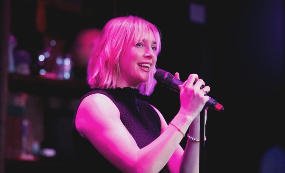 A storyteller on stage at About Last Night