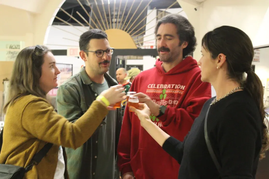 Guests raising a glass at Ales N' Rails