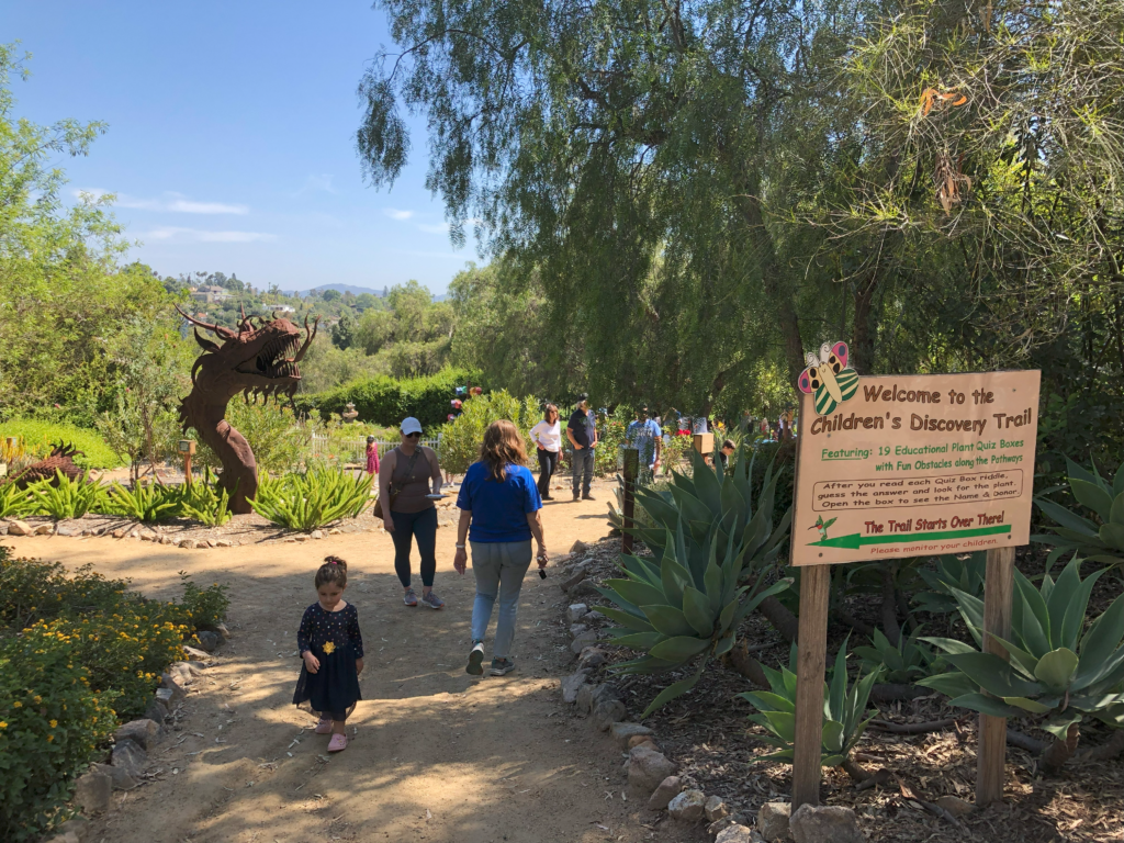 people walking around a garden