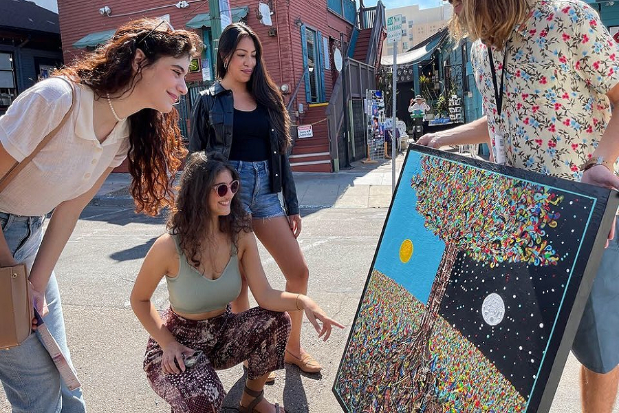 three women looking at artwork