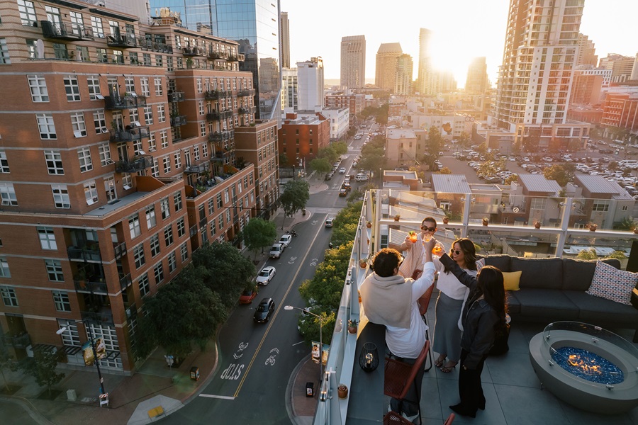 people drinking on a rooftop bar