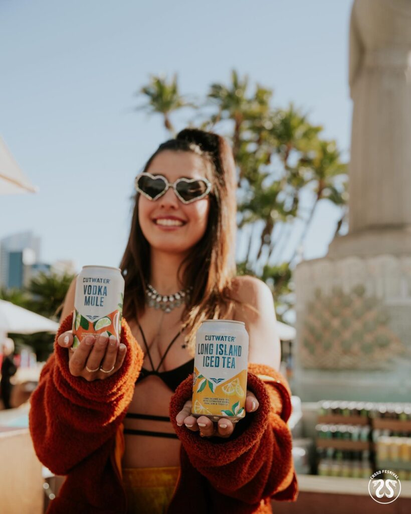 Woman holding two cans of beer