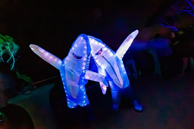 two people in glowing shark costume