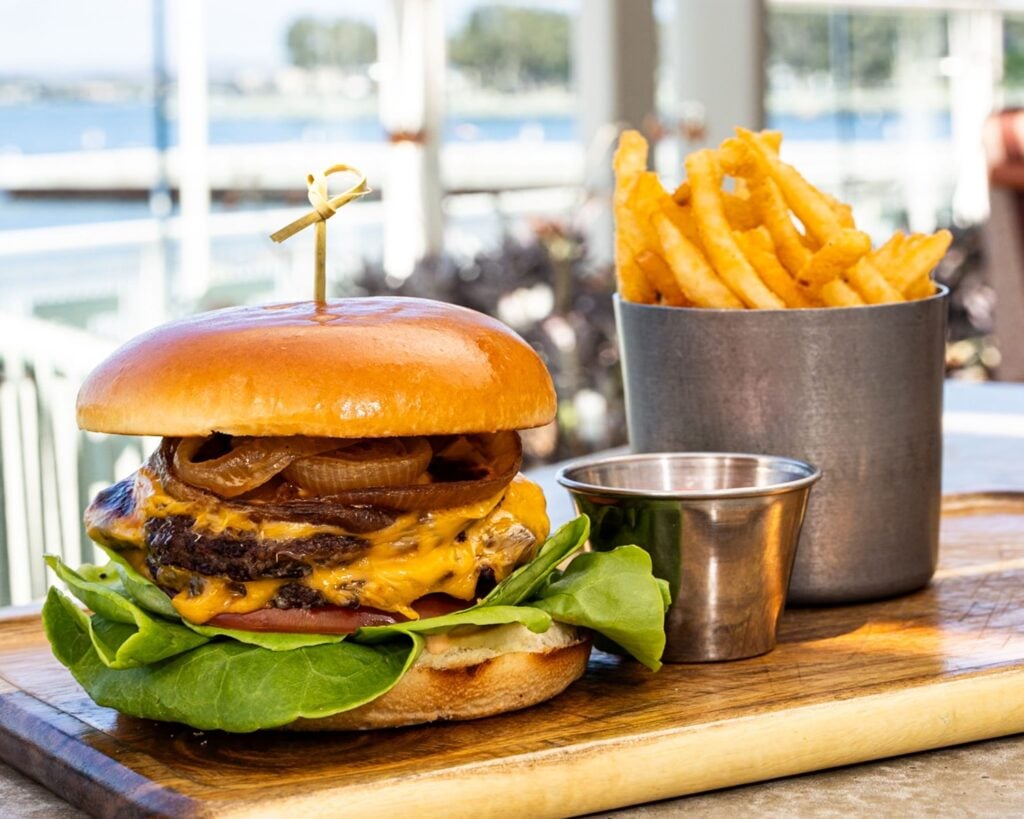 Hudson & Nash hamburger with a side of fries and dip