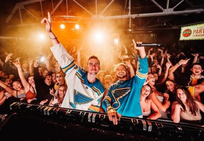 two guys wearing jerseys in a concert