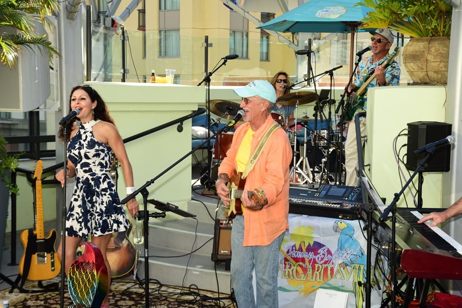 Live band performing during the rooftop benefit concert