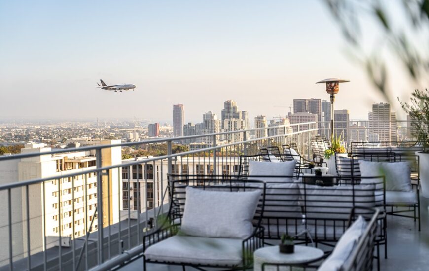 Mister A rooftop bar with an airplane passing by in the horizon