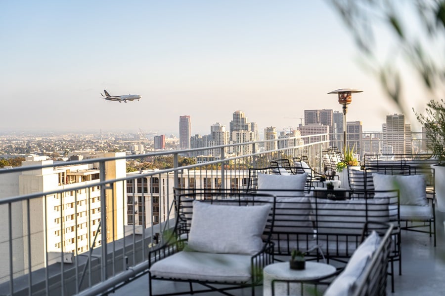 Mister A rooftop bar with an airplane passing by in the horizon