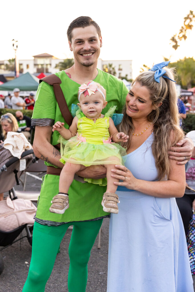 a family of three in halloween costumes