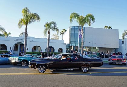 cars in front of a white building