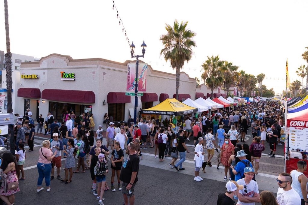 an array of kiosks and crowd walking and standing around