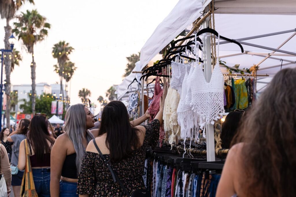 two women looking at clothes for sale