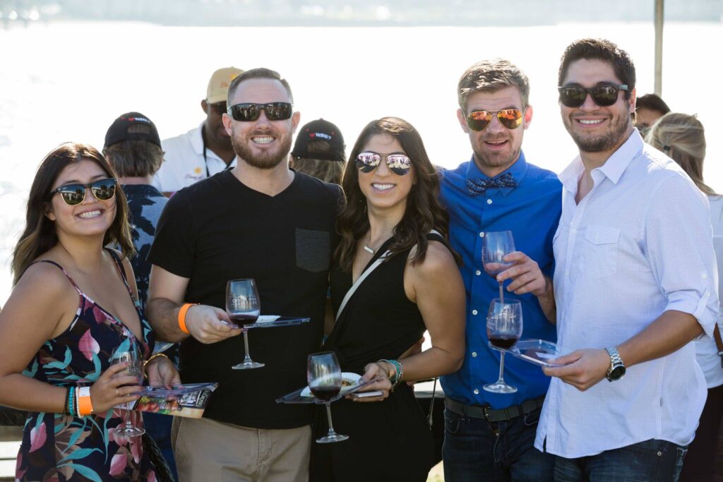 men and women holding wine glasses