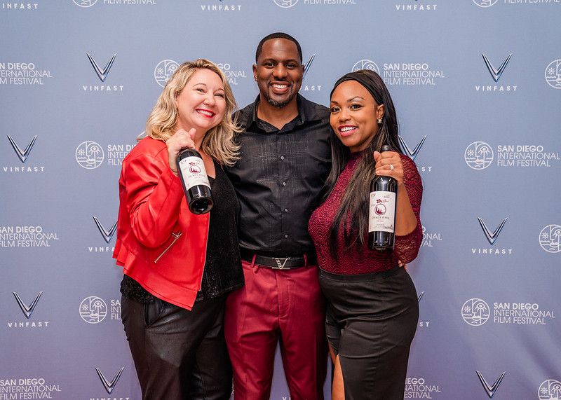 festival attendees holding wine bottles