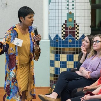 woman talking in front of students and parents