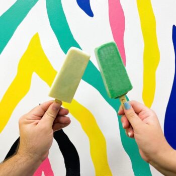 two hands holding a popsicle each