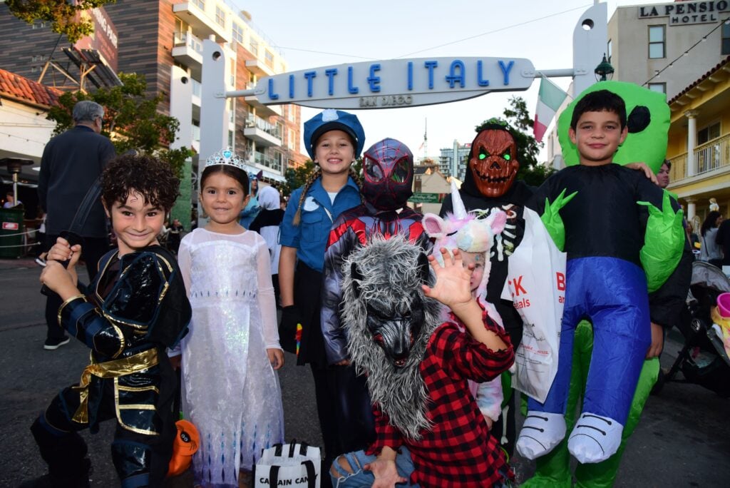 A festive street scene during Trick-or-Treat on India Street