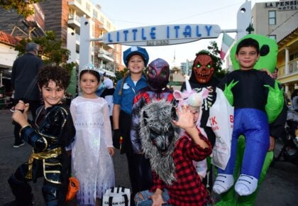 A festive street scene during Trick-or-Treat on India Street
