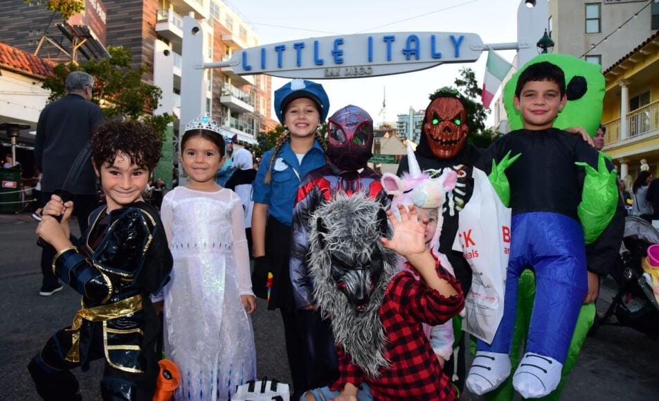 A festive street scene during Trick-or-Treat on India Street