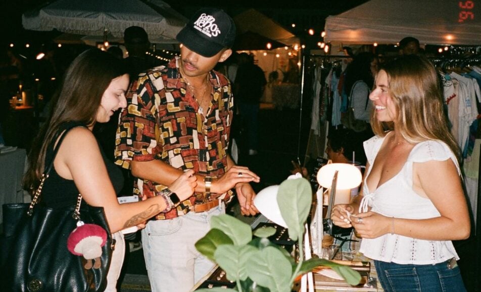 Shoppers browse local vendors at the Waves & Makers night market