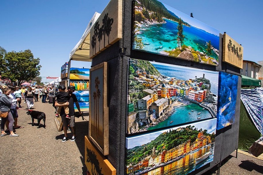 paintings on display at a street fair