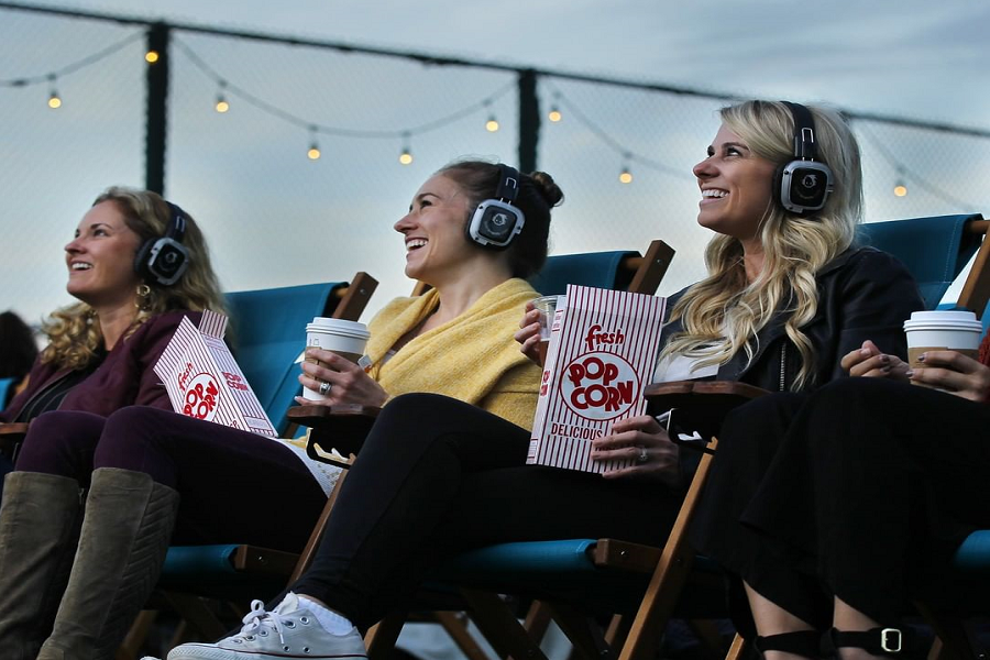 ladies watching a movie on a rooftop cinema