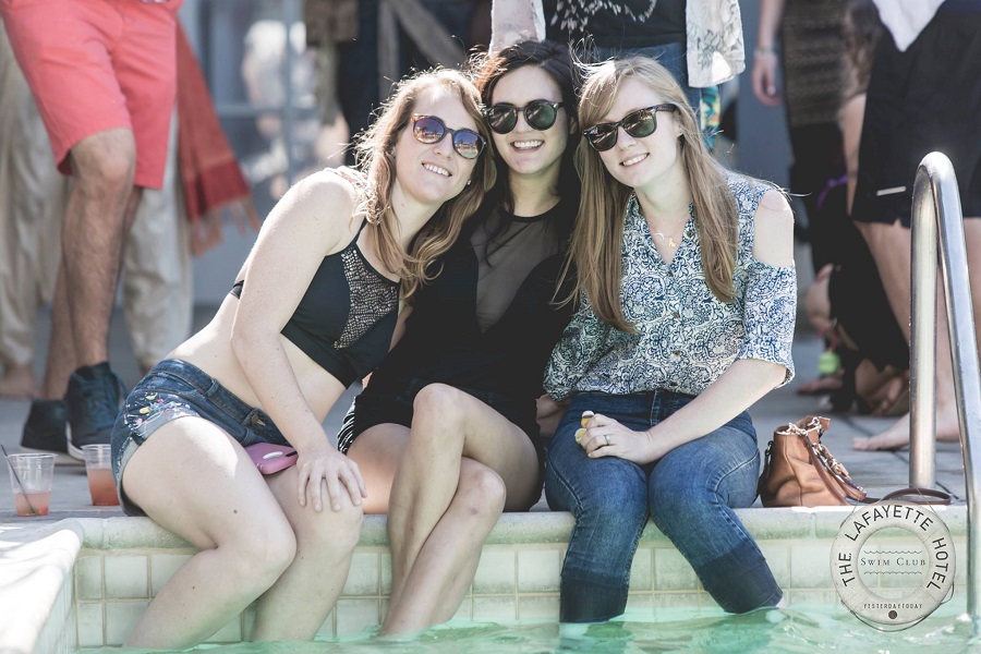 three ladies sitting by the side of the pool