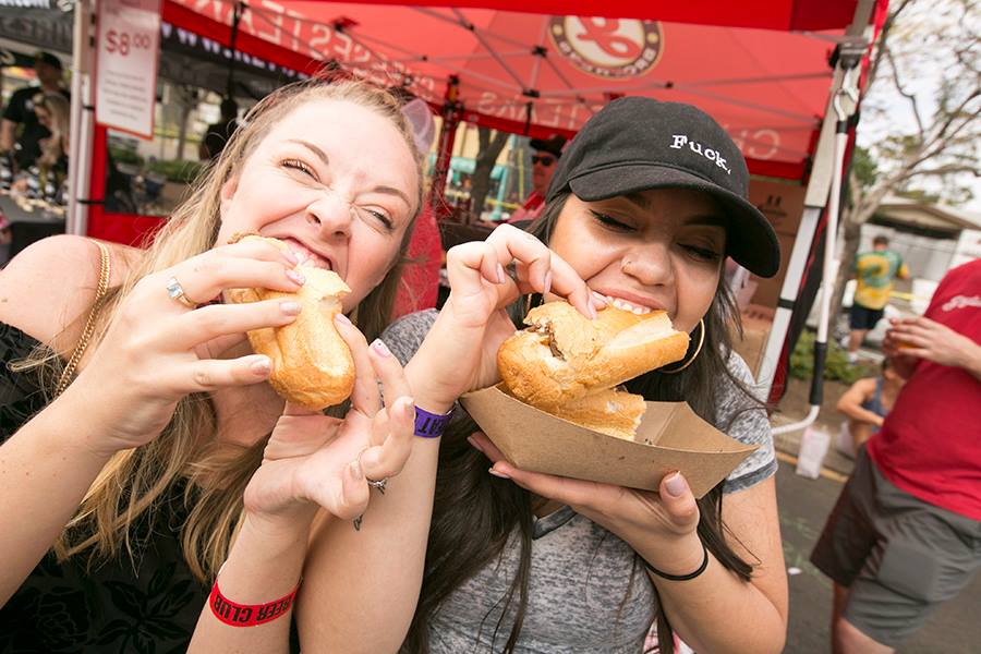 two women eating bagel at the North Park Festival of Beers