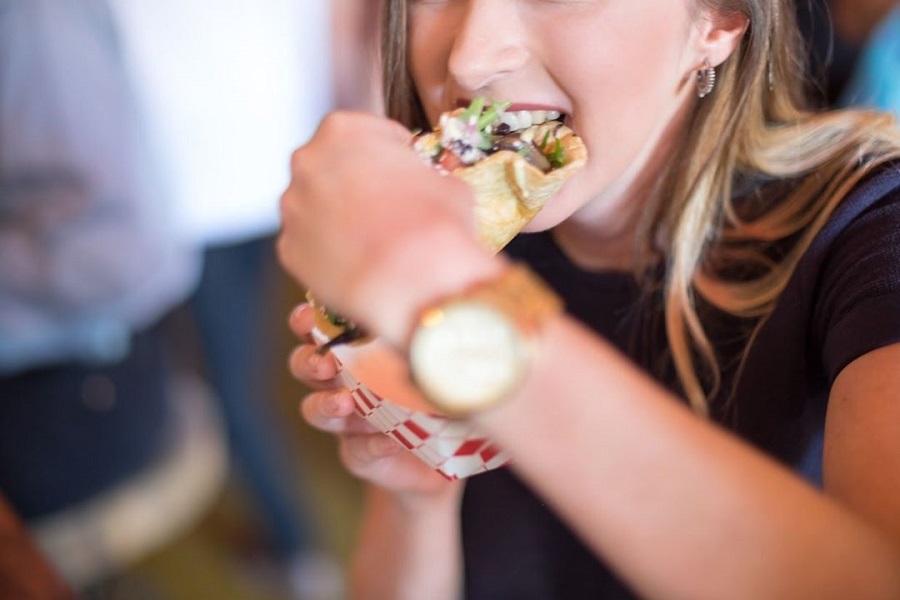 girl biting on a taco