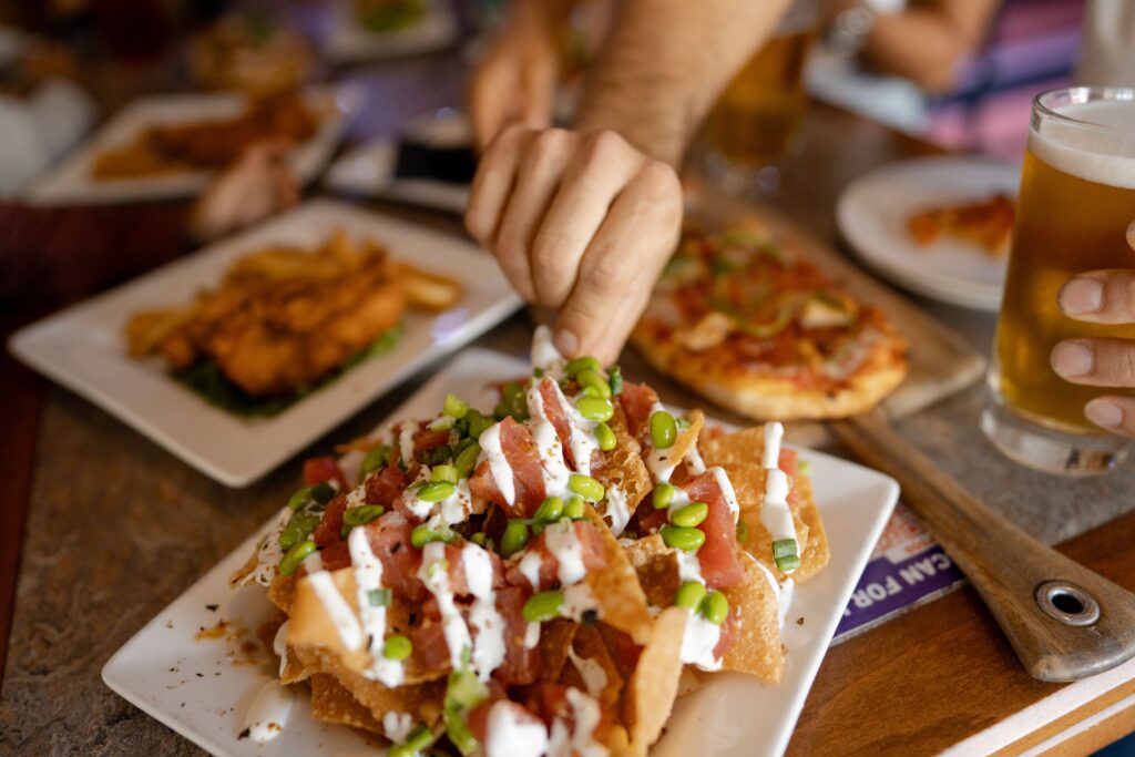 a hand reaching for nachos